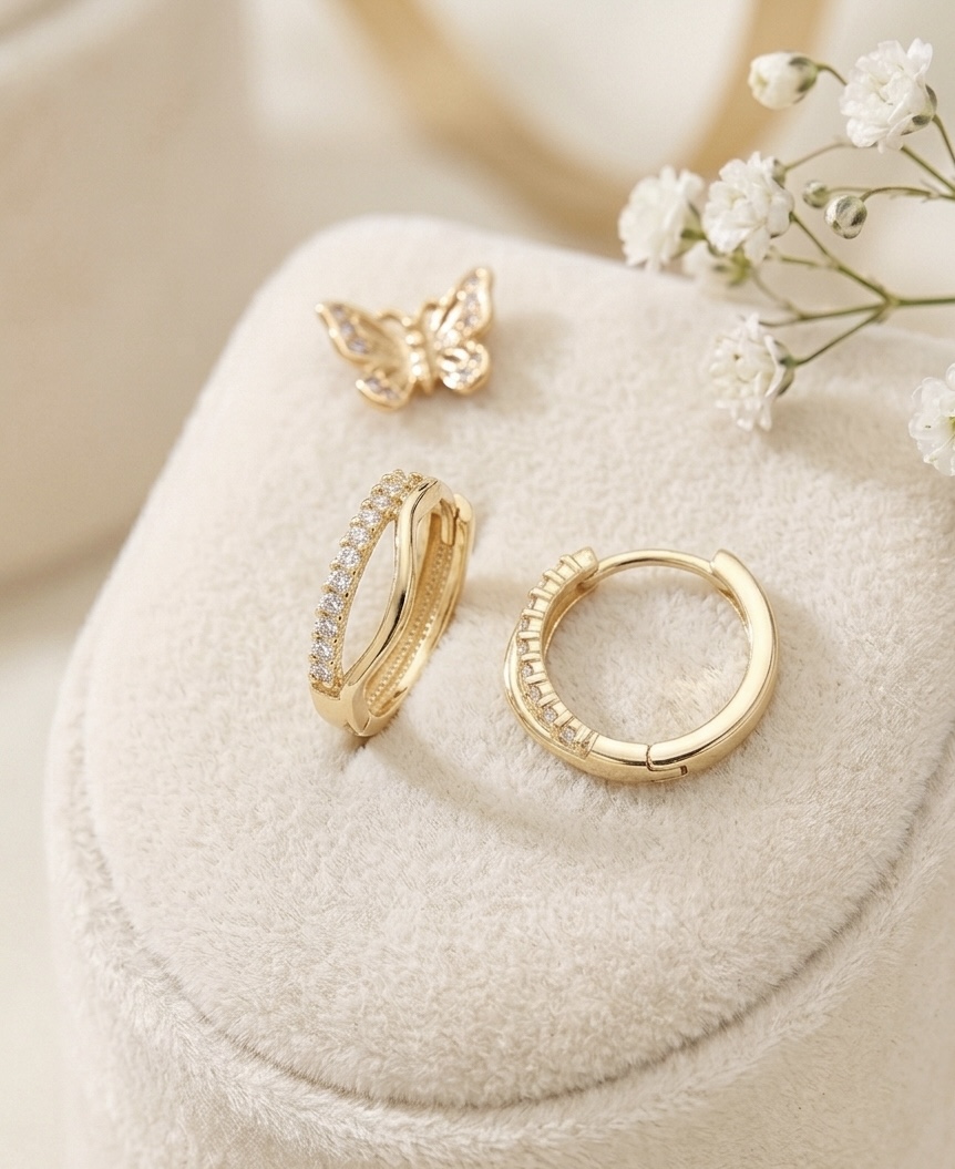 The first pair of gold earrings for children&mdash;delicate little hoop designs, perfect as a gift, in a gift box from ASTO Gold.